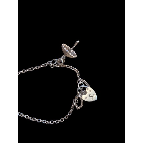 272 - A SILVER CHARM BRACELET WITH CHARMS