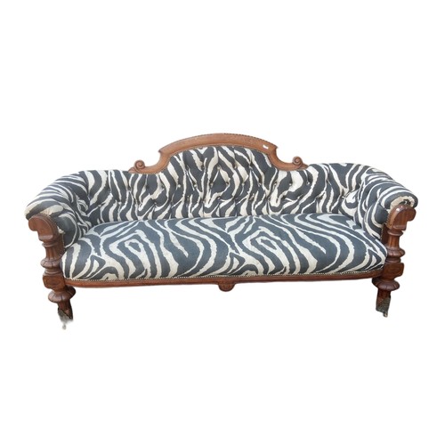 85 - A ZEBRA PRINT COUCH WITH  SOLID WOODEN FRAME WITH ORNATE BRASS COASTERS