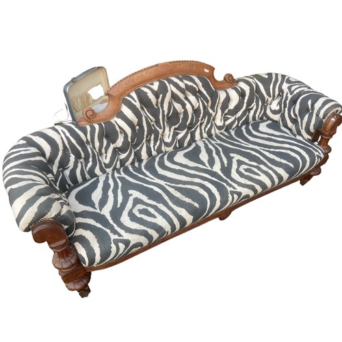 85 - A ZEBRA PRINT COUCH WITH  SOLID WOODEN FRAME WITH ORNATE BRASS COASTERS