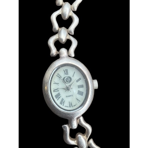 417 - A SILVER MOTHER OF PEARL FACE WATCH WITH A HEAVY SILVER INTERLINK BRACELET