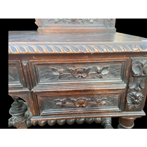 594 - A VICTORIAN CARVED OAK DESK ON HEAVY TURNED LEG ORNATE CARVINGS TO DRAWERS AND GALLERY TOP ALSO NICE... 