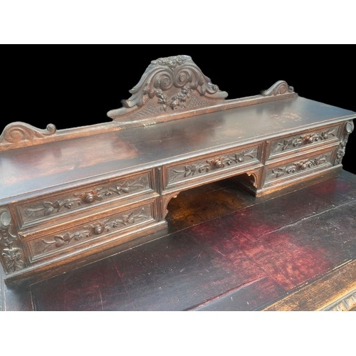 594 - A VICTORIAN CARVED OAK DESK ON HEAVY TURNED LEG ORNATE CARVINGS TO DRAWERS AND GALLERY TOP ALSO NICE... 