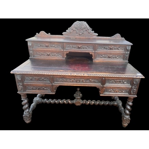 594 - A VICTORIAN CARVED OAK DESK ON HEAVY TURNED LEG ORNATE CARVINGS TO DRAWERS AND GALLERY TOP ALSO NICE... 