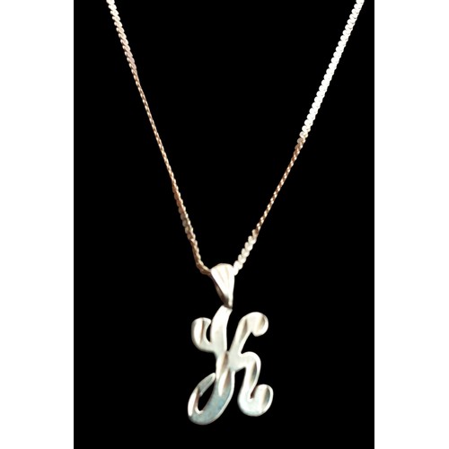 483 - A 14CT GOLD K PENDANT ON A 14CT GOLD CHAIN