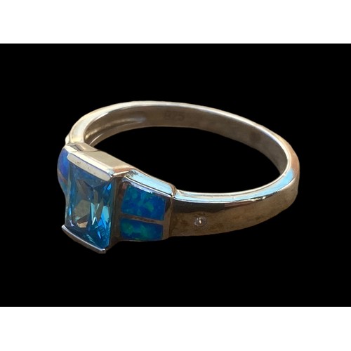 491 - A QUALITY TOPAZ AND OPAL STYLE SILVER RING