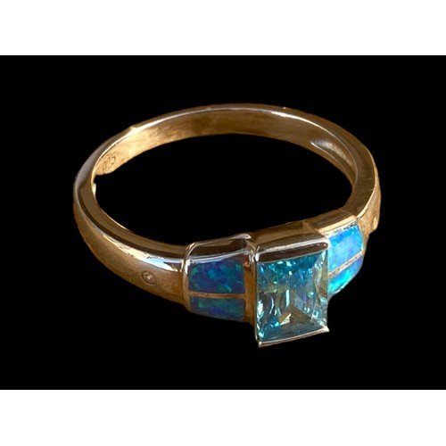 491 - A QUALITY TOPAZ AND OPAL STYLE SILVER RING