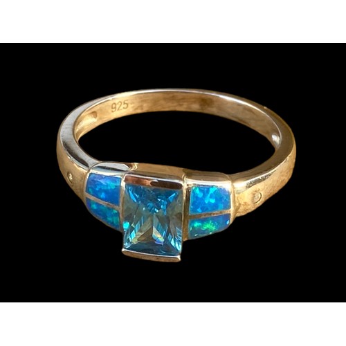 491 - A QUALITY TOPAZ AND OPAL STYLE SILVER RING