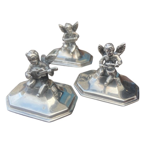 564 - A RARE SET OF 6 CAST SILVER MENU/PLACE NAME HOLDERS MODELLED AS A GROUP OF MINGED PUTI PLAYING VARIO... 