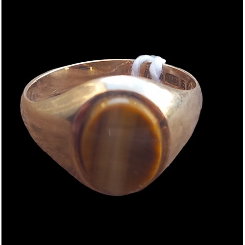 549 - A 9CT GOLD RING SET WITH A BEAUTFIUL TIGERS EYE STONE