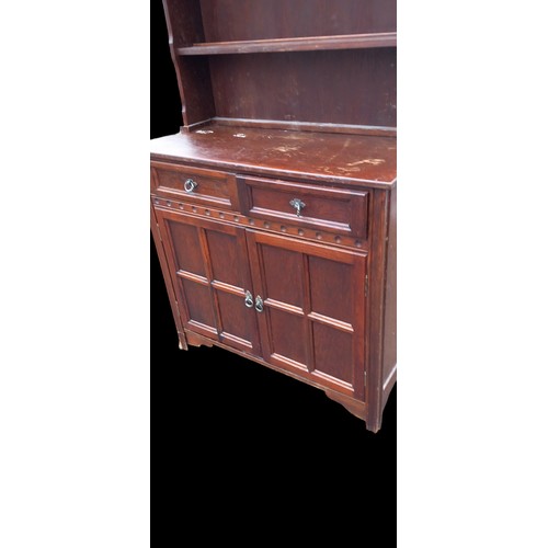 14 - A NEAT SIZE DARK OAK DRESSER WITH PANEL DOORS