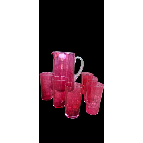 63 - ANTIQUE RUBY GLASS JUG AND 6 GLASSES