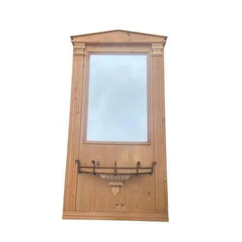 100 - AN ORNATE CARVED PINE MIRROR