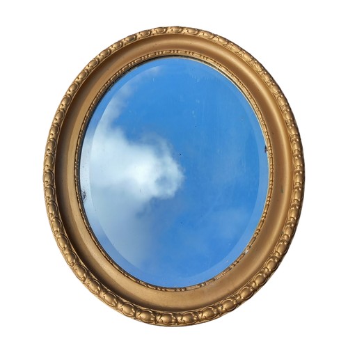 122 - OVAL FRAMED GILT BEVELLED EDGE MIRROR