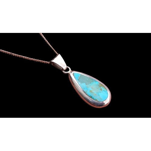 156 - A SILVER AND TURQUOISE PENDANT ON SILVER CHAIN