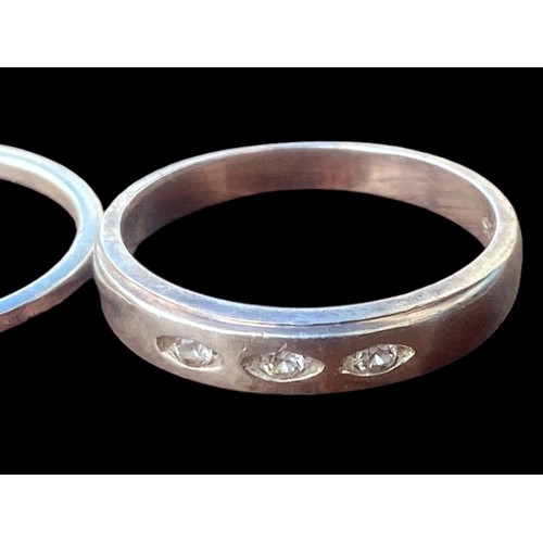 196 - 2 SILVER RINGS- CLEAR BAND & ONE SET WITH 3 STONES