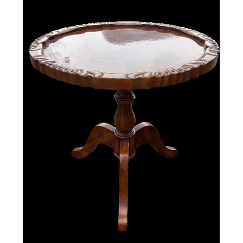 147 - AN ORNATELY CARVED WALNUT TABLE ON TRIPOD BASE