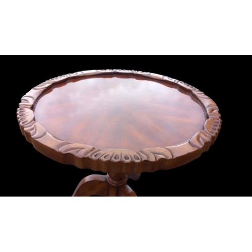 147 - AN ORNATELY CARVED WALNUT TABLE ON TRIPOD BASE