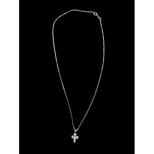 186 - A SILVER GEM SET CROSS ON A SILVER CHAIN