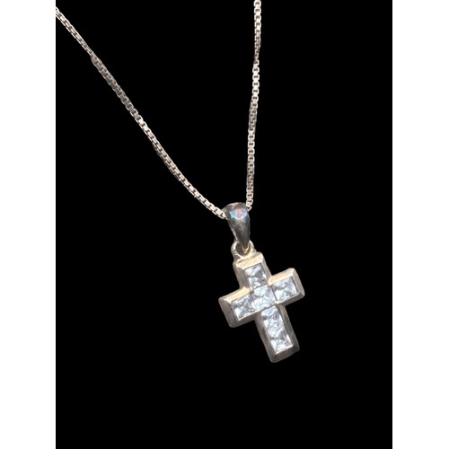 186 - A SILVER GEM SET CROSS ON A SILVER CHAIN