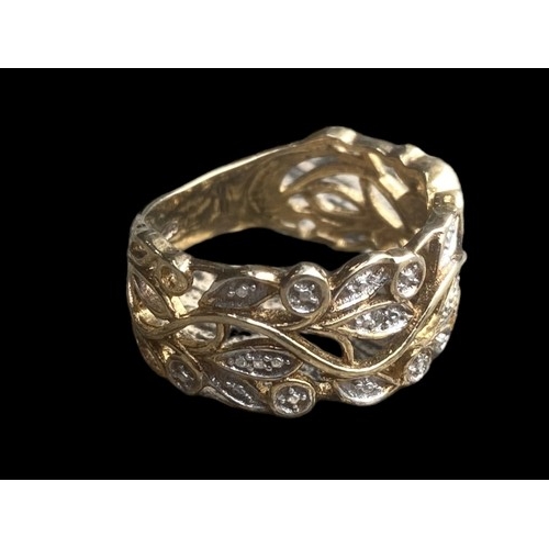 195 - A SILVER GILT GEM SET OPENWORK RING WITH FOLIAGE DESIGN