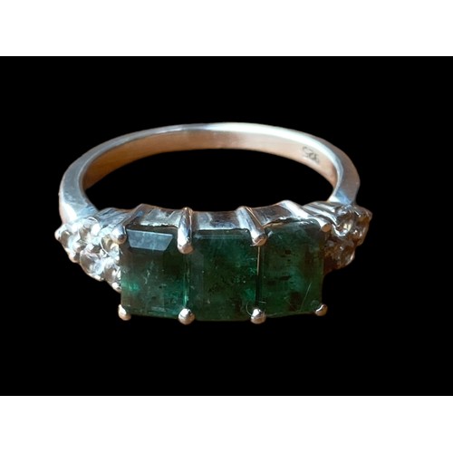 245 - A SILVER GEMSET RING WITH 3 GREEN STONE