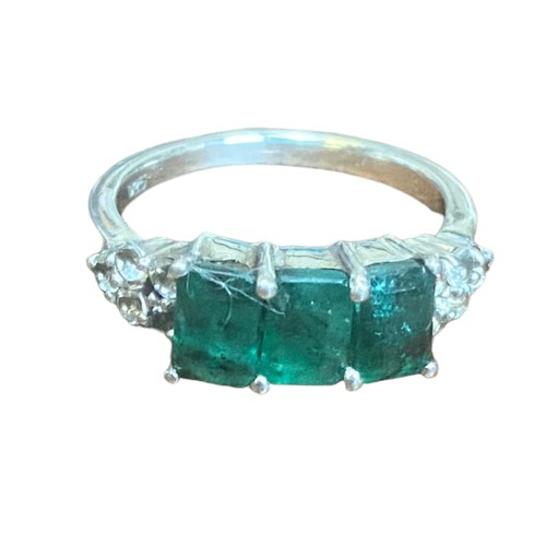 245 - A SILVER GEMSET RING WITH 3 GREEN STONE