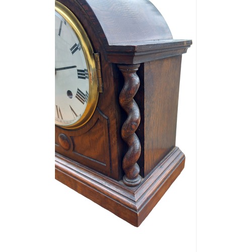 312 - AN OAK  MANTLE CLOCK WITH TWIST PILLARS