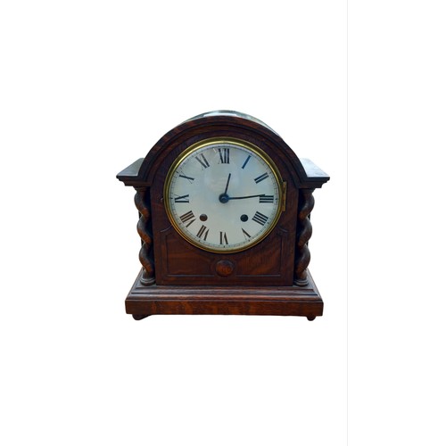 312 - AN OAK  MANTLE CLOCK WITH TWIST PILLARS