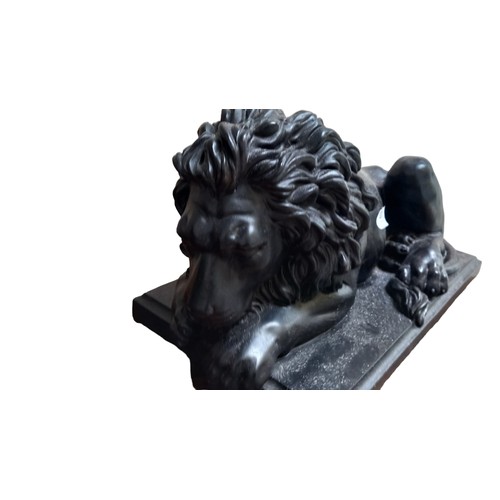 381 - AN EBONY RESIN LION 17X8