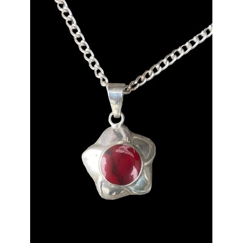 407 - A LARGE SILVER PENDANT SET WITH RED STONE ON A LONG HEAVY SILVER CHAIN