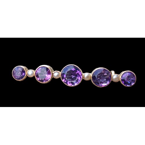 590 - BAR BROOCH SET WITH 5 ROUND AMETHYSTS IN RUB OVER SETTING WITH PEARLS BETWEEN EACH STAMPED AND MADE ... 