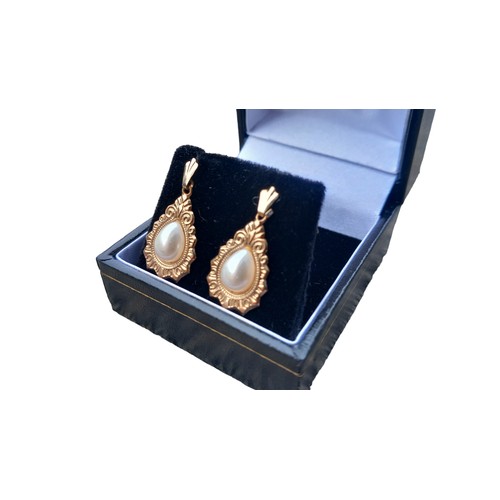 576 - A PAIR OF 9ct GOLD PEAR DROP EARRINGS