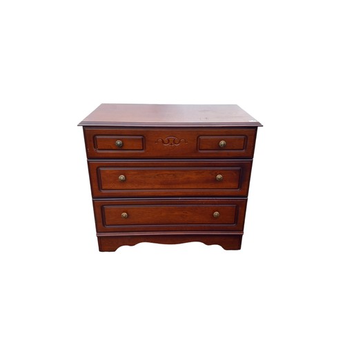 657 - A MAHOGANY CHEST OF DRAWERS WITH CARVED DECORATION TO FRONT