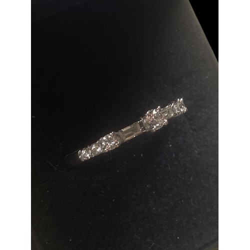 575A - 750k ETERNITY RING WITH 6 CUT DIAMONDS AND 2 BAGUETTE CUT DIAMONDS SIZE O 2.48gms