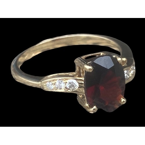 577D - 18ct YELLOW GOLD OVEL RED STONE RING SET IN 4 CLAWS WITH 3 DIAMONDS TO EACH SHOULDER SIZE M 2.70gms