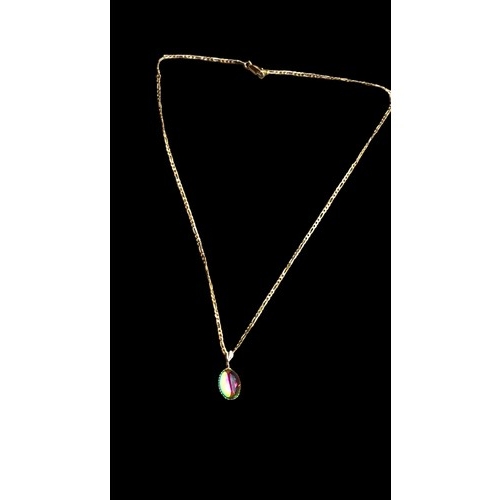 A 9CT GOLD MYSTIC TOPAZ PENDANT ON YELLOW METAL CHAIN