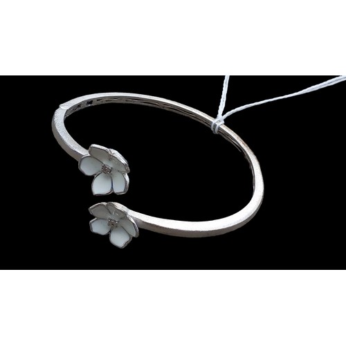 174 - A SILVER BANGLE WITH FLOWER SETTING (DIAMOND CENTRE)