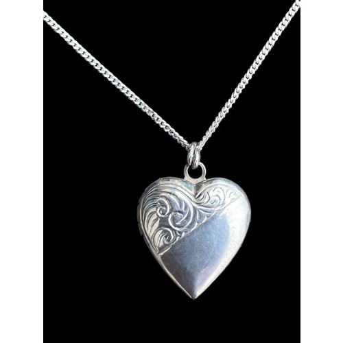 197 - AN ORNATE SILVER HEART LOCKET ON A SILVER CHAIN