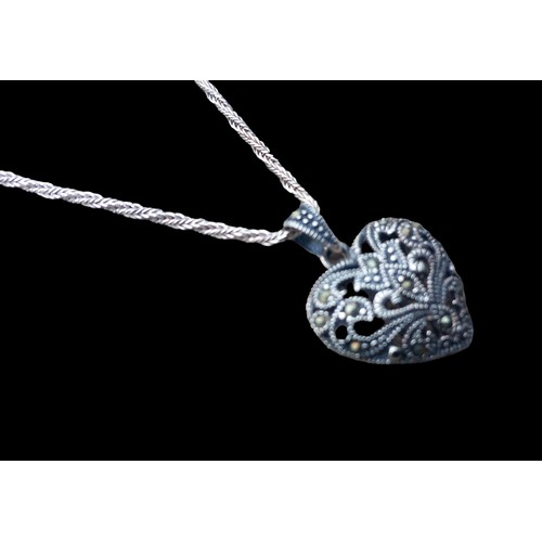 217 - A SILVER AND MARCASITE HEART PENDANT ON A HEAVY SILVER TWIST CHAIN