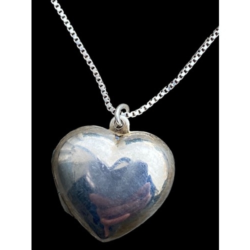 272 - A SILVER HEART LOCKET ON A LONG SILVER CHAIN