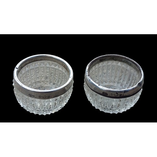 295 - A PAIR OF ANTIQUE GLASS SALTS WITH BIRMINGHAM SILVER RIMS DATED 1902 BY HENRY WILLIAMSON LTD