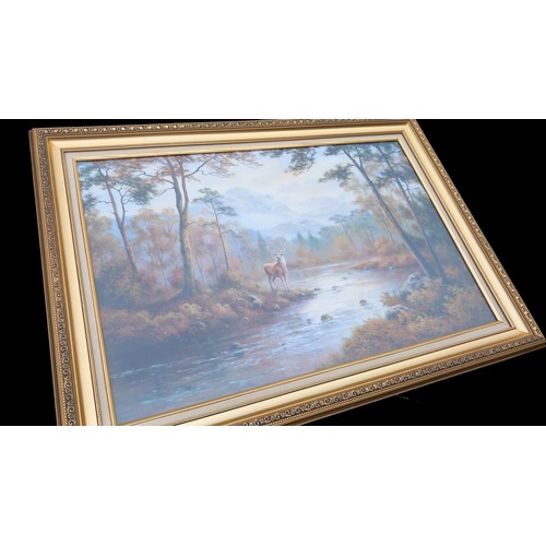 323 - A LARGE FLORAL GILT FRAMED PRINT OF A STAG IN WOODLAND 42x30