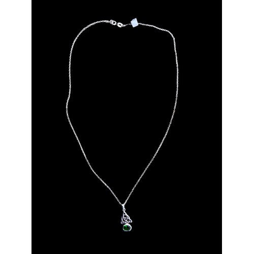 509 - A CELTIC SILVER PENDANT SET WITH A GREEN STONE ON A SILVER CHAIN