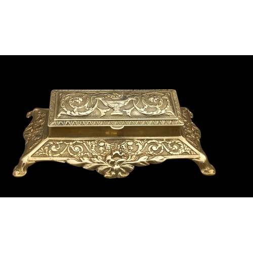 576 - AN ORNATE HEAVY BRASS DESK TIDY