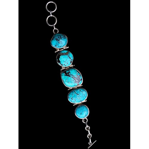 530 - A HEAVY SILVER BRACELET SET WITH LARGE TURQUOISE STONES