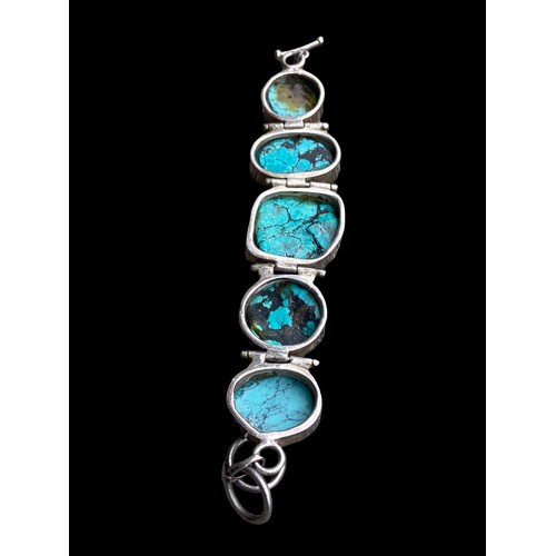 530 - A HEAVY SILVER BRACELET SET WITH LARGE TURQUOISE STONES