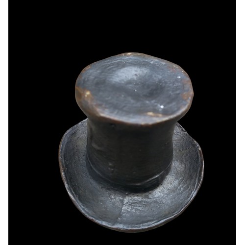 557 - A MINITURE BRONZE TOP HAT