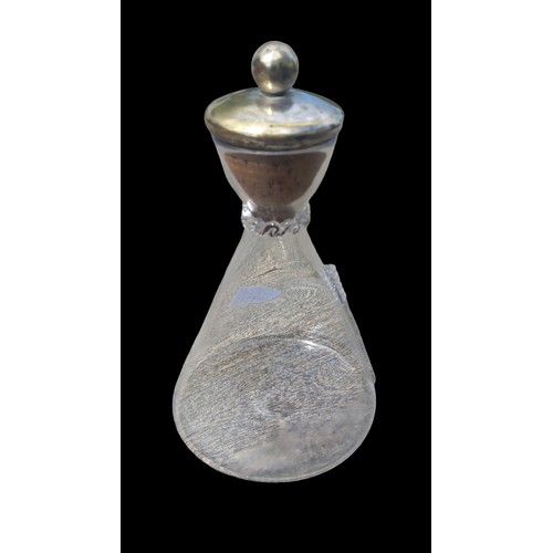 380 - AN ANTIQUE GLASS DECANTERWITH A LARGE CORK STOPPER 10