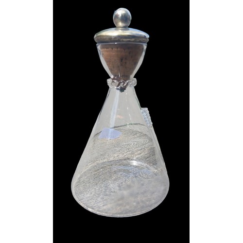 21 - AN ANTIQUE GLASS DECANTERWITH A LARGE CORK STOPPER 10
