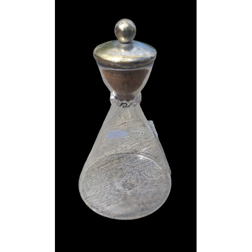 21 - AN ANTIQUE GLASS DECANTERWITH A LARGE CORK STOPPER 10